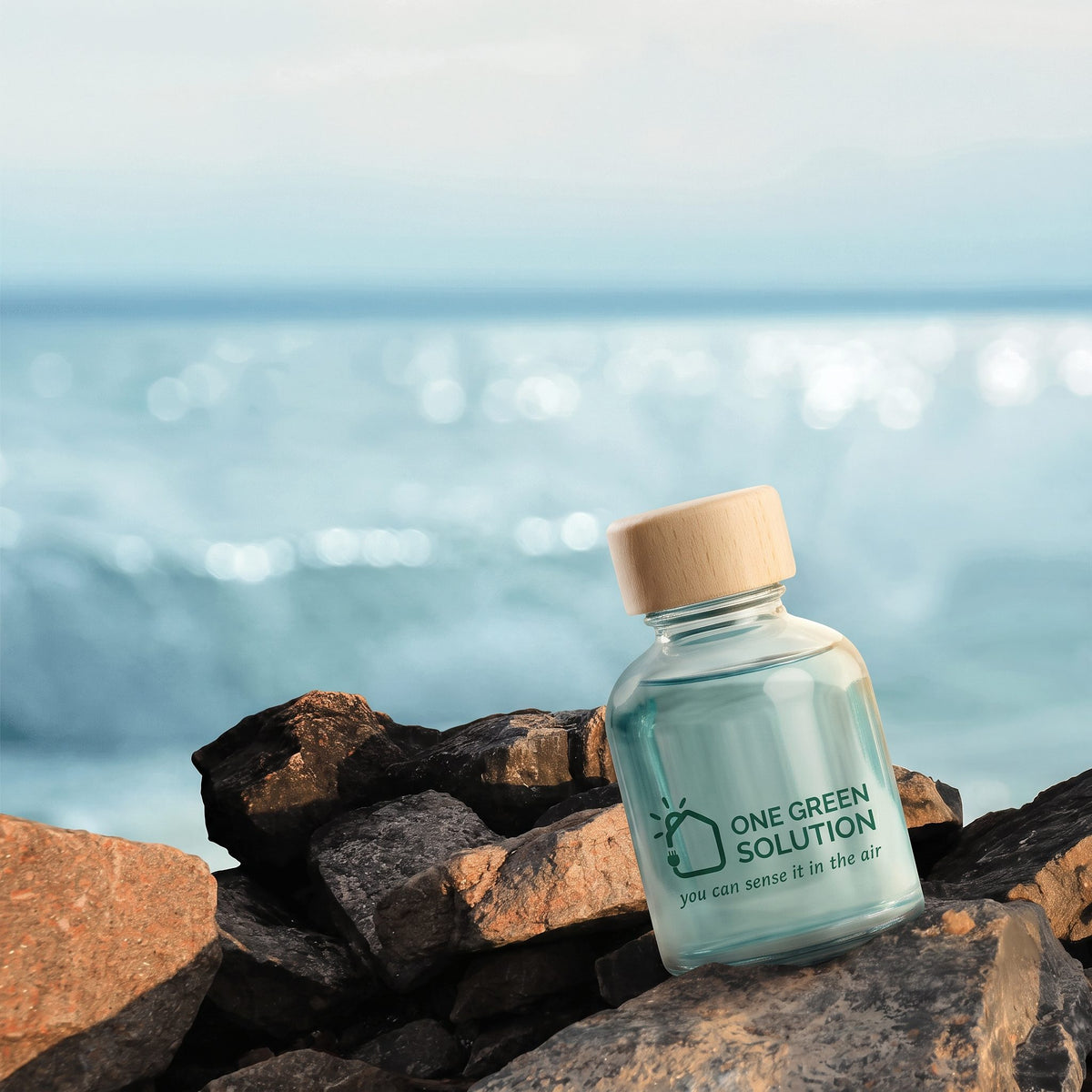 Ocean Breeze Signature Scent oil bottle with light blue oil on seaside rocks